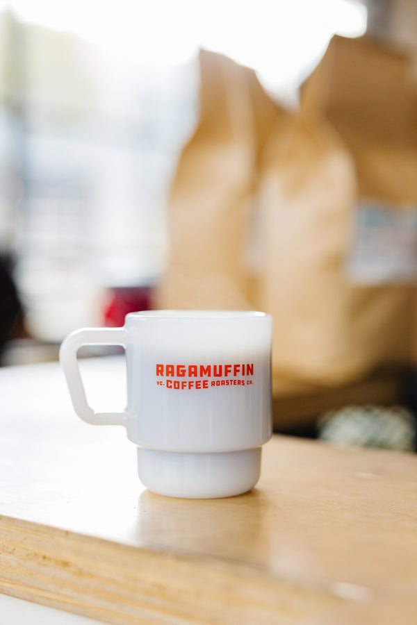 White milk glass espresso cup with red Ragamuffin logo