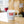 White milk glass espresso cup with red coffee cup people holding hands