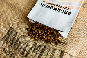 Bag of coffee beans spilled on a burlap bag